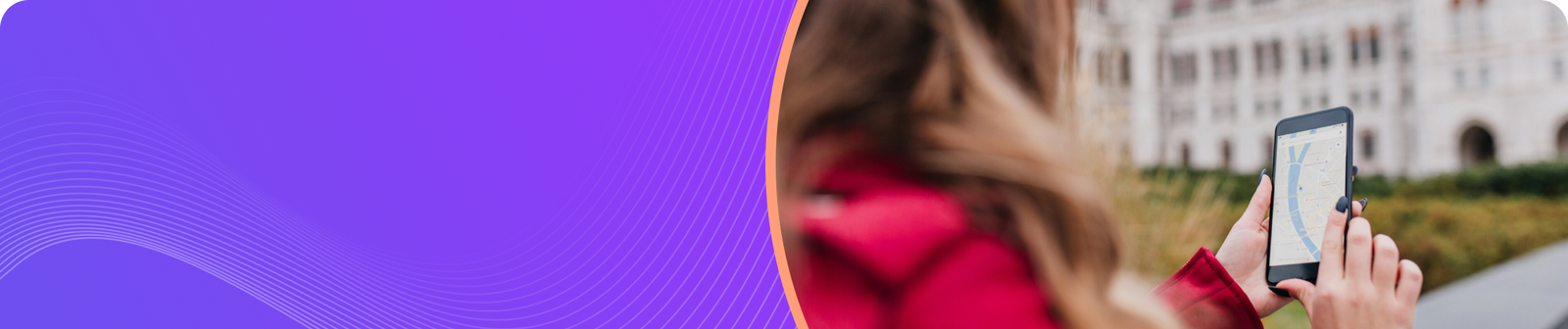 Woman in a red jacket using a smartphone to view a map outdoors in an urban setting.