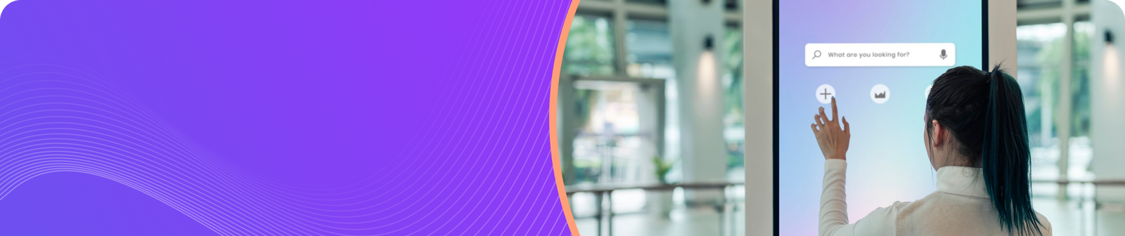 Person interacting with a digital touchscreen in a modern, open space with vibrant colors.