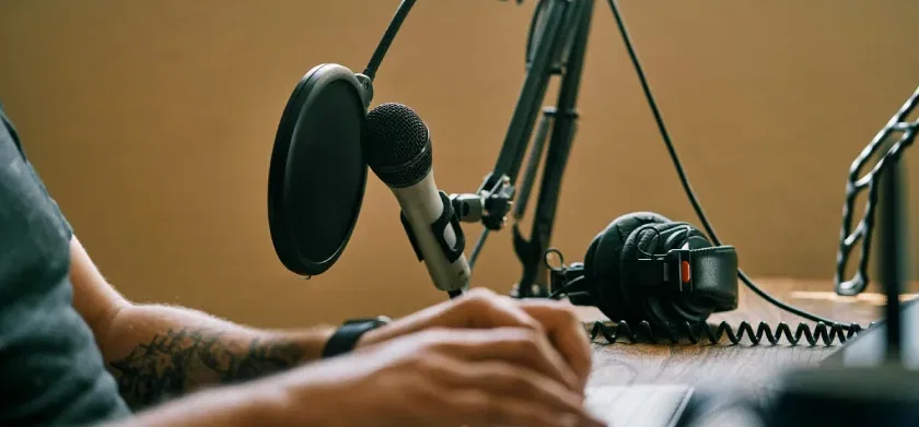 Person holding microphone adding an audio file to Articulate Storyline 360 course