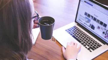 Woman using laptop discovering closing digital divides: ReadSpeaker TTS and the 2024 National Edtech Plan