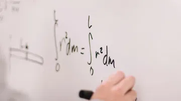 Make STEM accessible with LaTeX and ReadSpeaker - Person writing on white board.