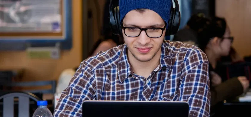 Man wearing headphones learns how ReadSpeaker TTS works with Anthology Ally (formerly Blackboard Ally)