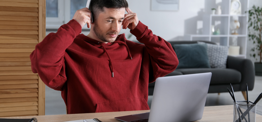 Man with headphones using a laptop.
