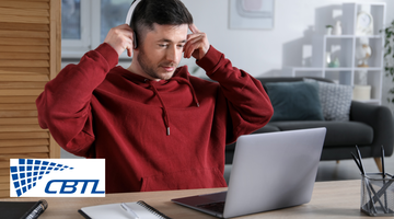 Man with headphones using a laptop.