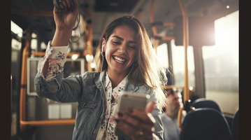 Mobile user consuming audio-supported content on a smartphone during a public transport commute