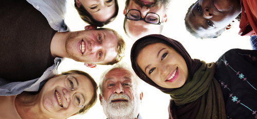 Concept of ReadSpeaker multilingual Neural TTS expressed via image of people of different cultures in a circle looking down ,